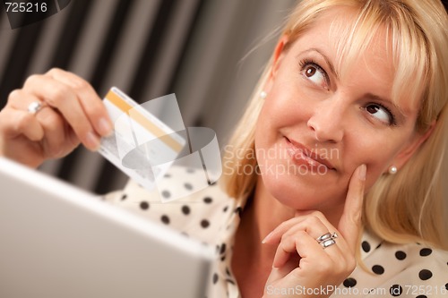Image of Beautiful Woman Using Laptop Holding Her Credit Card