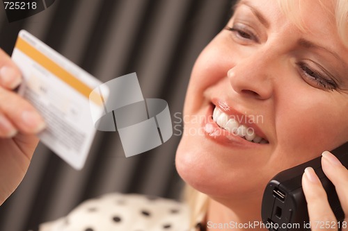 Image of Beautiful Woman on Phone Holding Credit Card