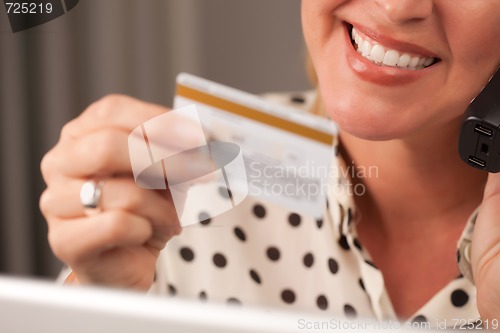 Image of Beautiful Woman on Phone Holding Credit Card