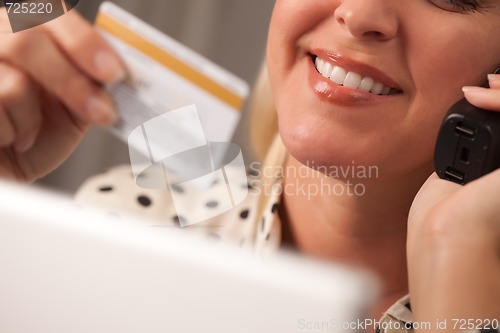 Image of Beautiful Woman on Phone Holding Credit Card
