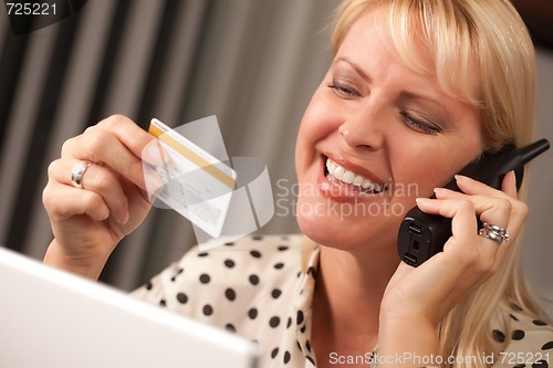 Image of Beautiful Woman on Phone Holding Credit Card