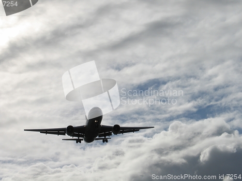 Image of Landing plane silhouette on a cloudy day