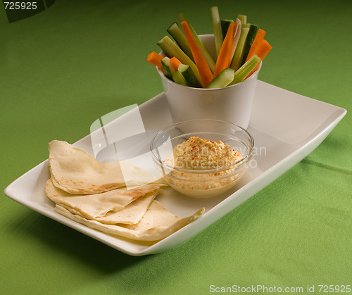 Image of hummus dip with pita brad and vegetable