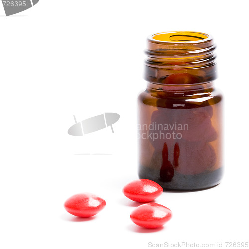 Image of bottle with red pills