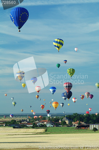 Image of hot air ballloons flying over french village