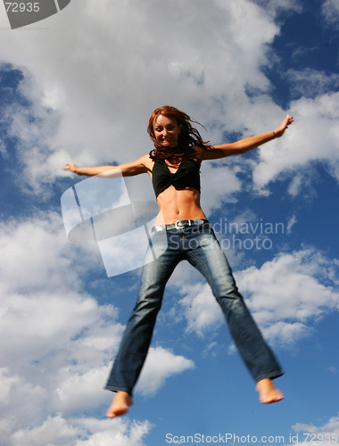 Image of Woman jumping of joy