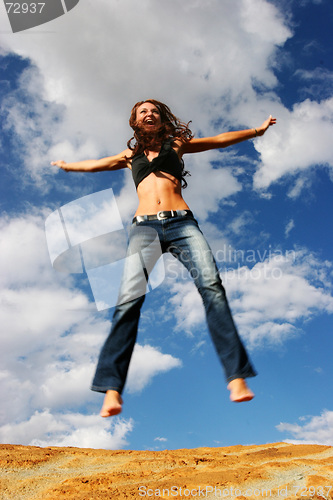 Image of Woman jumping of joy