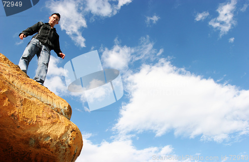 Image of Man standing on top of the world
