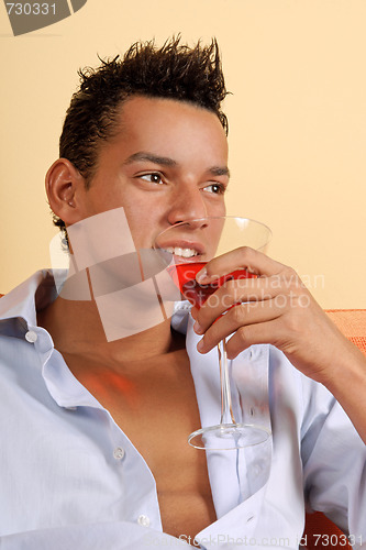 Image of Smiling young man with cocktail