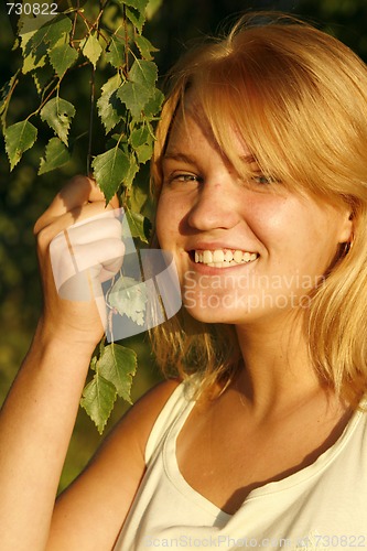 Image of Young blond girl smiling happily