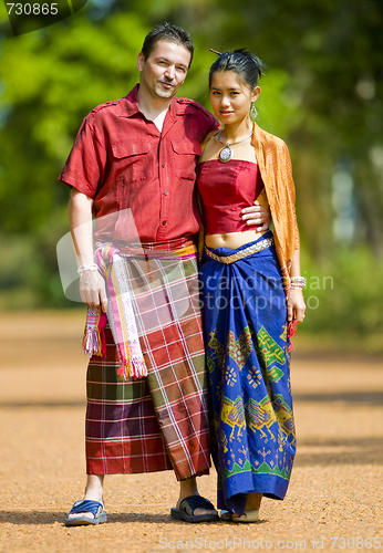 Image of caucasian and asian with traditional thai clothes