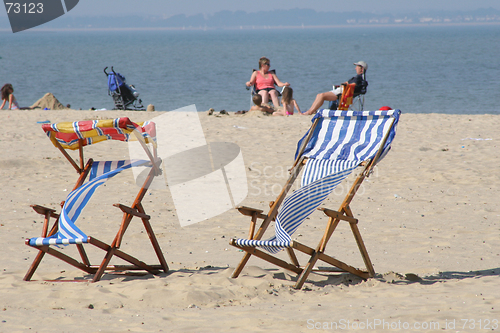 Image of colorful deckchairs on beach