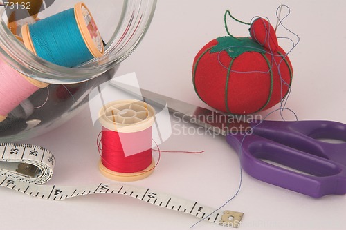 Image of Sewing thread, tape, scissors and pin cushion