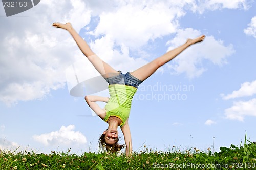 Image of Young girl doing cartwheel