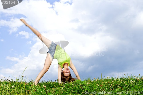 Image of Young girl doing cartwheel