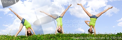 Image of Young girl doing cartwheel