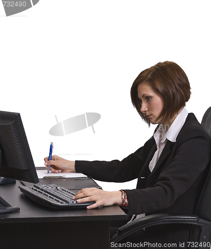 Image of Businesswoman taking notes at her desk.