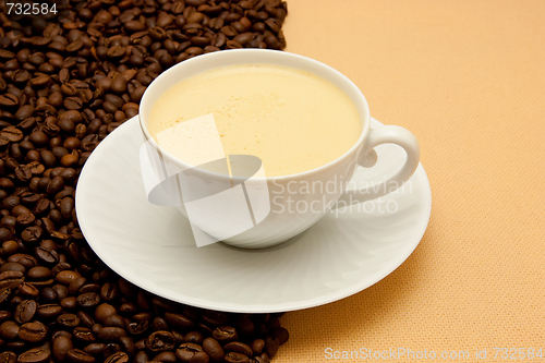 Image of White cup of coffee and coffee beans