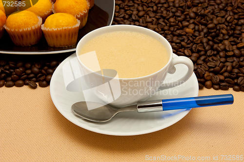 Image of White cup of coffee and coffee beans