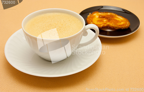 Image of Closeup of coffee with milk in white cup and a palmier pastry