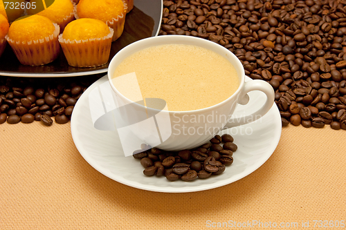 Image of White cup of coffee and coffee beans