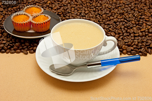 Image of White cup of coffee and coffee beans