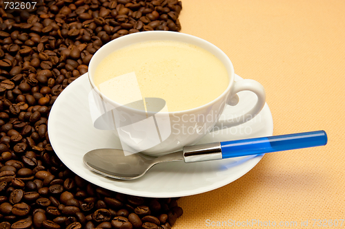 Image of White cup of coffee and coffee beans