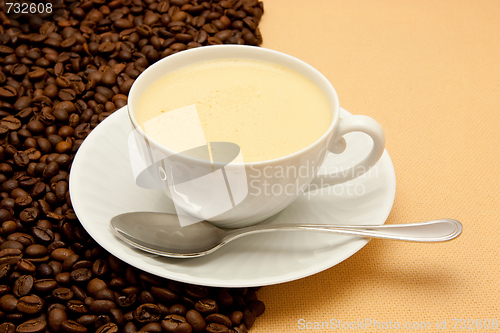 Image of White cup of coffee and coffee beans