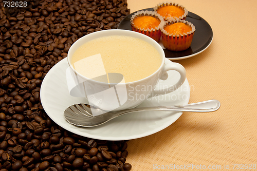 Image of White cup of coffee and coffee beans