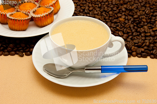 Image of White cup of coffee and coffee beans