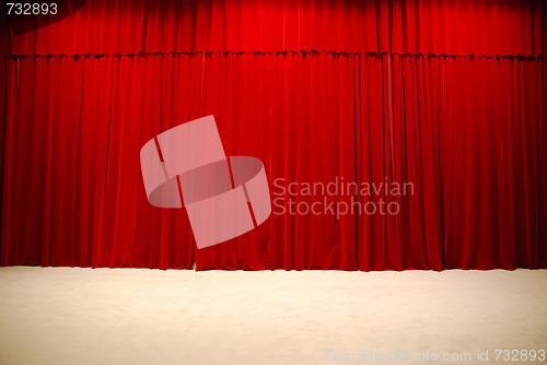 Image of Red draped theater stage curtains