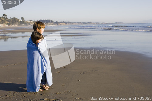 Image of Kids in Blanket at Beach