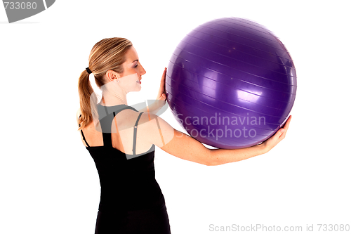 Image of Young woman doing yoga ball exercises isoalted