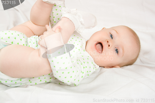 Image of Baby plays with her legs