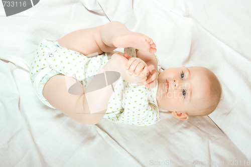 Image of Baby plays with her legs