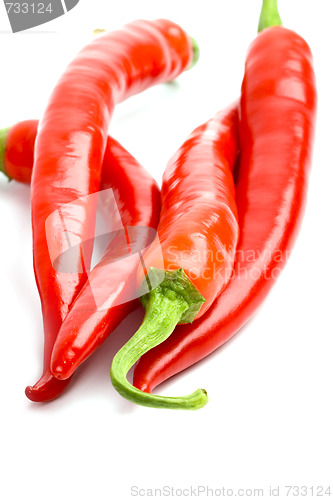 Image of four red chilly peppers