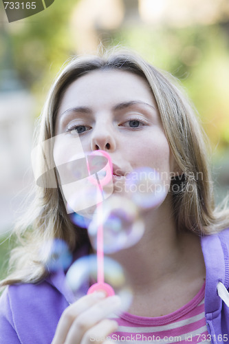 Image of Teen Girl Blowing Bubbles