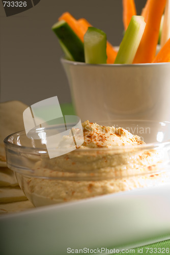 Image of hummus dip with pita bread and vegetable