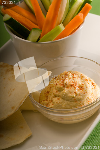 Image of hummus dip with pita bread and vegetable