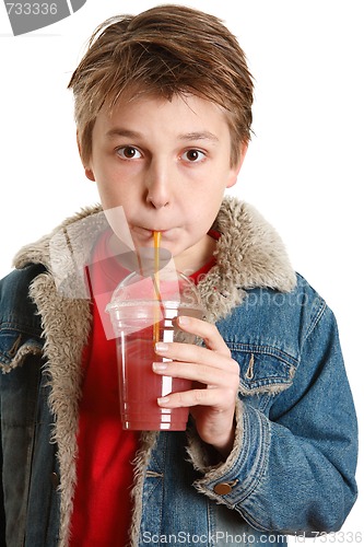 Image of Child drinking fresh fruit juice through a straw