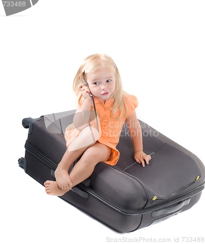 Image of Little girl and suitcase in studio