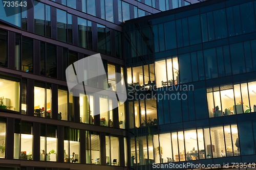 Image of office building from glass in the night with the windows