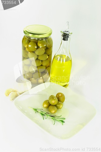 Image of Stuffed pickled Olives in dish with olive oil. 