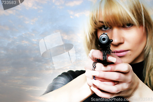 Image of pretty woman with pistol in to hand 