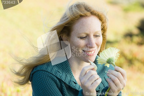 Image of Woman Outdoors With Flower