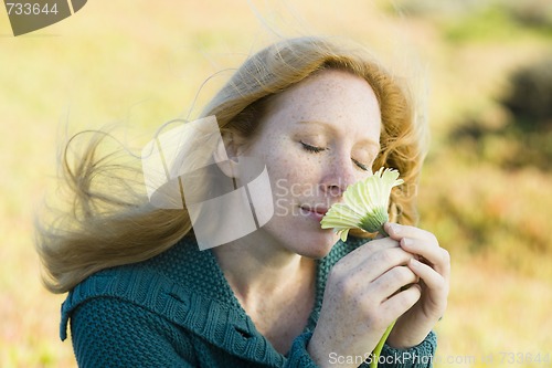 Image of Woman Smelling Flower