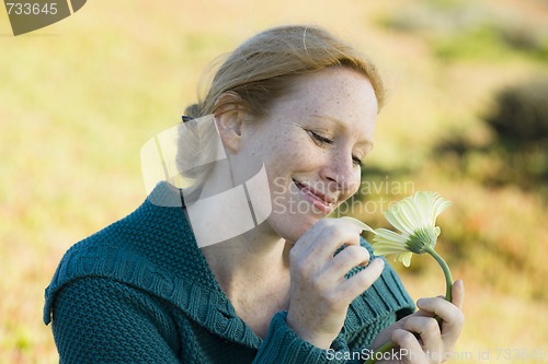 Image of Woman Outside with Flower