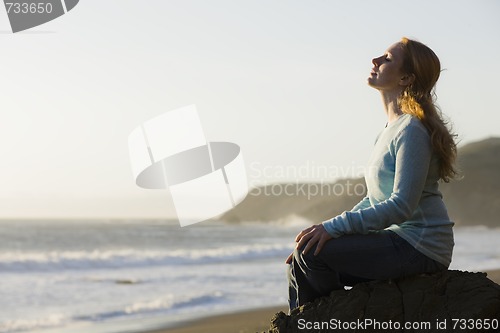 Image of Woman Sitting on Rock