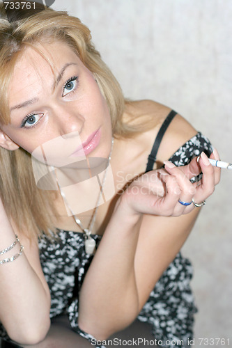 Image of portrait beautiful girl smokes cigarette 