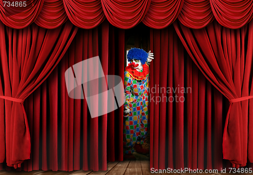 Image of Creepy Clown Looking Through Stage Curtain Drapes